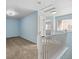 Bright upstairs hallway featuring fresh paint, neutral carpet, and a charming white railing at 7234 E 38Th Ave, Denver, CO 80207