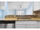 Kitchen view with granite countertops, stainless steel appliances, and a double basin sink at 7234 E 38Th Ave, Denver, CO 80207