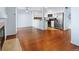 Spacious living area with hardwood flooring, fireplace, and an open layout to the kitchen at 7234 E 38Th Ave, Denver, CO 80207