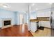 Open-concept living space featuring hardwood floors, a fireplace, and a bright kitchen at 7234 E 38Th Ave, Denver, CO 80207