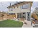 Modern two-story home with a fenced yard featuring an artificial lawn and outdoor seating at 3188 W 28Th Ave, Denver, CO 80211