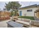Backyard with small artificial lawn, a wood fence, and outdoor seating on the patio at 3188 W 28Th Ave, Denver, CO 80211