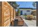 Landscaped backyard with wood fence, artificial lawn, wooden planter, and outdoor lighting at 3188 W 28Th Ave, Denver, CO 80211