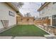 A home's backyard with new artificial grass, a wood fence, and modern outdoor seating at 3188 W 28Th Ave, Denver, CO 80211