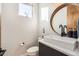 Modern half-bathroom featuring a stylish mirror, sleek vanity, and contemporary fixtures at 3188 W 28Th Ave, Denver, CO 80211