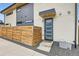 Charming front entrance with a modern door, stylish wood fencing, and concrete steps at 3188 W 28Th Ave, Denver, CO 80211