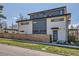 Modern, multi-level home with sleek design, contrasting colors, and a wood fence at 3188 W 28Th Ave, Denver, CO 80211