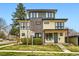 Modern two-story home with a brick accent, well-manicured lawn, front porch, and inviting curb appeal at 3188 W 28Th Ave, Denver, CO 80211