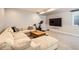 A cozy living room with a sectional couch, TV, and exercise bike at 3188 W 28Th Ave, Denver, CO 80211