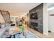 Open-concept living room with a fireplace, hardwood floors, and seamless flow to the kitchen at 3188 W 28Th Ave, Denver, CO 80211