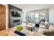 Cozy living room with a modern fireplace, plush sofa, and access to the outdoor area at 3188 W 28Th Ave, Denver, CO 80211