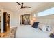 Spacious main bedroom featuring a ceiling fan, barn door, and large window overlooking the neighborhood at 3188 W 28Th Ave, Denver, CO 80211