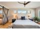 Bright main bedroom with a ceiling fan, barn door, and a view from three horizontal windows at 3188 W 28Th Ave, Denver, CO 80211