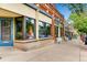 Commercial building with a blue door, large display windows, and sidewalk seating for customers at 3188 W 28Th Ave, Denver, CO 80211