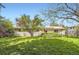 Large backyard with a well-manicured lawn, mature trees, and a fence for privacy at 4056 E Orchard Rd, Centennial, CO 80121