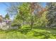 Spacious backyard featuring lush green grass, mature trees, and a privacy fence at 4056 E Orchard Rd, Centennial, CO 80121