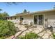Exterior of the home featuring a large patio with outdoor seating and mature landscaping at 4056 E Orchard Rd, Centennial, CO 80121