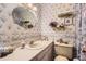 Quaint bathroom with floral wallpaper, vanity with sink, and decorative mirror at 4056 E Orchard Rd, Centennial, CO 80121