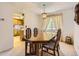 Bright dining room featuring a wood table, natural light, neutral carpet, and access to the kitchen at 4056 E Orchard Rd, Centennial, CO 80121