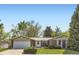 Inviting single-story brick home with a well-maintained lawn and a two-car attached garage at 4056 E Orchard Rd, Centennial, CO 80121