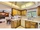 Functional kitchen offering wood cabinetry, white counters, and ample natural light from the window at 4056 E Orchard Rd, Centennial, CO 80121