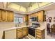 Bright kitchen features wood cabinets, white countertops, appliances, and a window over the sink at 4056 E Orchard Rd, Centennial, CO 80121
