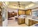 Traditional kitchen provides wood cabinets, white countertops, a ceiling fan, and access to the living spaces at 4056 E Orchard Rd, Centennial, CO 80121