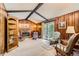 Spacious living room features wood paneling, carpeted floors, fireplace, and a large bookcase at 4056 E Orchard Rd, Centennial, CO 80121
