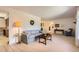 Spacious living room with neutral carpet, traditional furnishings, and open access to kitchen and other rooms at 4056 E Orchard Rd, Centennial, CO 80121