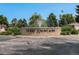 Entrance to Three Fountains community with beautiful landscaping and an American flag in the background at 3210 S Oneida Way, Denver, CO 80224