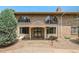 Charming brick townhouse featuring arched windows, a covered entrance, and well-maintained landscaping at 3210 S Oneida Way, Denver, CO 80224
