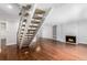 Living room featuring hardwood floors, fireplace, and built-in shelves at 3210 S Oneida Way, Denver, CO 80224