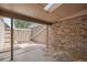 Outdoor patio features a brick wall, a sun roof, and a partially fenced area for added privacy at 3210 S Oneida Way, Denver, CO 80224