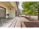 Private patio with rocking chair and street view at 13950 E Oxford Pl # A115, Aurora, CO 80014