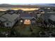 Aerial view of home with fenced yard and beautiful lake in the background at 2882 Heron Lakes Pkwy, Berthoud, CO 80513
