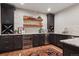 This bar has a stone backsplash, granite countertops, and shelves at 2882 Heron Lakes Pkwy, Berthoud, CO 80513
