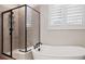 Elegant bathroom features a modern bathtub, frameless glass shower, and bright natural light at 2882 Heron Lakes Pkwy, Berthoud, CO 80513