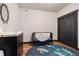 Charming Bedroom with wood floors, a playful rug, and a modern crib at 2882 Heron Lakes Pkwy, Berthoud, CO 80513