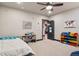 This bedroom includes a ceiling fan and toy storage at 2882 Heron Lakes Pkwy, Berthoud, CO 80513