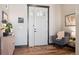 Warm and inviting foyer features hardwood floors, a stylish rug, and a comfortable seating area at 2882 Heron Lakes Pkwy, Berthoud, CO 80513
