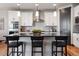 Bright kitchen showcasing white cabinetry, sleek countertops, modern appliances, and a stylish island with seating at 2882 Heron Lakes Pkwy, Berthoud, CO 80513