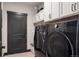 Efficient laundry room with modern washer and dryer, ample storage, and convenient layout at 2882 Heron Lakes Pkwy, Berthoud, CO 80513