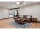 Open-concept living room with bar seating, wood floors, and stylish decor at 2882 Heron Lakes Pkwy, Berthoud, CO 80513