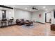 Spacious living room with wood floors, leather sofa, and stylish decor at 2882 Heron Lakes Pkwy, Berthoud, CO 80513