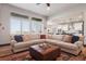 Bright living room features large windows, comfortable sectional sofa, and stylish decor at 2882 Heron Lakes Pkwy, Berthoud, CO 80513