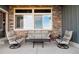 This covered patio is furnished with comfortable seating at 2882 Heron Lakes Pkwy, Berthoud, CO 80513