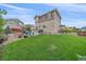 Spacious backyard featuring a well-maintained lawn, patio, garden beds, and privacy fence at 23831 Eagle Bend Ln, Parker, CO 80138