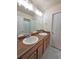 Bathroom featuring double sinks, a large mirror, and white cabinets at 23831 Eagle Bend Ln, Parker, CO 80138
