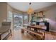 Bright dining area featuring a rustic wood table, sliding glass door, and stylish décor at 23831 Eagle Bend Ln, Parker, CO 80138