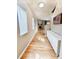 Hallway featuring hardwood floors, white trim, and a view of the fireplace at 23831 Eagle Bend Ln, Parker, CO 80138